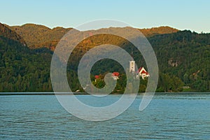 Scenic autumn morning landscape of Lake Bled Blejsko Jezero with the Pilgrimage Church of the Assumption of Maria.