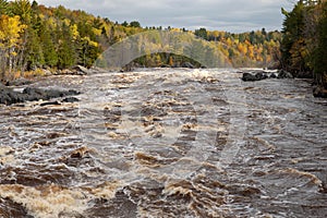 Scenic Autumn woods along the rushing rapids of the St. Louis River at Jay Cooke State Park in Northern MinnesotaRushing rapids of