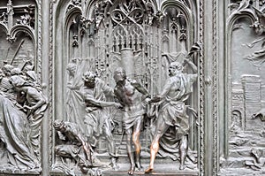 Scenic bas-relief with Jesus Christ on Milan Cathedral Duomo facade, Italy