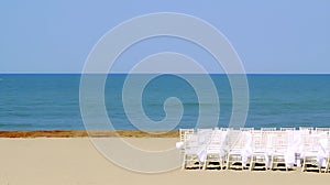 Scenic Beach Setting with White Chairs for Celebration and Ample Space for Inscription