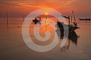 A scenic beauty of traditional fishing boat with sunset view