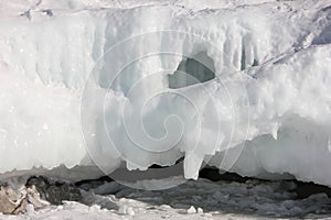 Scenic blue clear transparent ice Lake Baikal. Smooth surface deep cracks. Tourists people walk travel. Cinematic High mountains