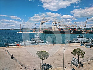 Scenic city view of Luka Koper at Adriatic seaside, Slovenia. Commercial cargo sea port with container cranes and ships.