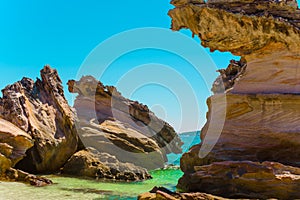 Scenic cliffs on a sandy tropical Thai beach.