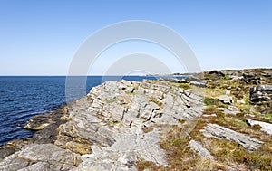 Scenic coastal landscape with geological formation layers in Kvernevik suburb