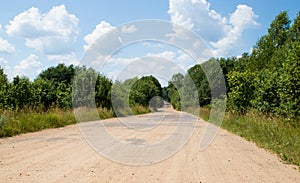 scenic country road with single tree and heavy clouds