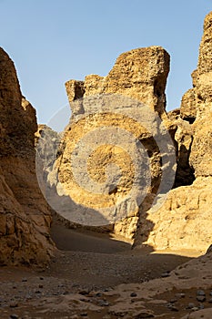 Scenic desert trail winds through a rocky formation, adorned with sparse trees in Namibia