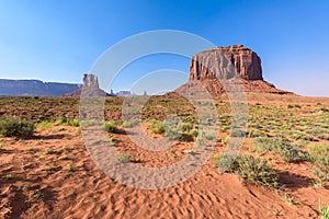 Scenic Drive on Dirt Road through Monument Valley, The famous Buttes of Navajo tribal Park, Utah - Arizona, USA. Scenic road and