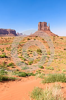 Scenic Drive on Dirt Road through Monument Valley, The famous Buttes of Navajo tribal Park, Utah - Arizona, USA. Scenic road and