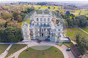 scenic drone shot of the front side of Wollaton Hall and visitors entering there, Nottingham, UK