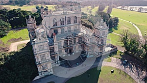 scenic drone shot of the front side of Wollaton Hall and visitors entering there, Nottingham, UK