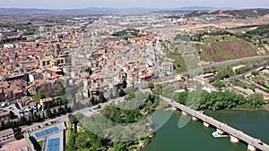Scenic drone view of Spanish city of Tudela located in Ebro river valley overlooking ancient arched stone bridge and