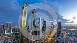 Scenic Dubai downtown architecture day to night timelapse. Top view over Sheikh Zayed road with illuminated skyscrapers