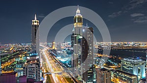 Scenic Dubai downtown architecture night timelapse. Top view over Sheikh Zayed road with illuminated skyscrapers and
