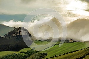 Scenic fog coming on italian hills and Canossa castle, Emilia Romagna photo