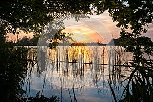 Scenic glimpse of the setting sun over a lake