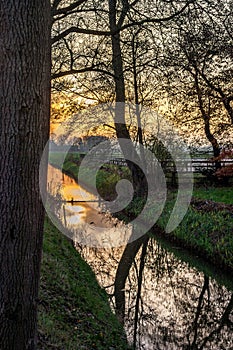 Scenic golden sunset over a canal in Holland