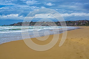 Scenic gray-blue clouds during sunrise over coastline with sandy beach and clear sea water in Agrigento, Sicily, Italy, summer