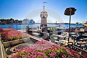 Scenic harbor of Oslo in Aker Brygge with clock tower view photo
