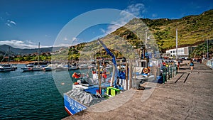 Scenic harbor view with multiple boats docked in the water in Mochiko, Portugal