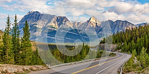 Scenic Highway in Canadian Rocky Mountains. Sunny Cloudy day. Banff, Alberta, Canada