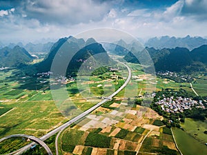 Scenic highway in Guangxi province of China surrounded with rice fields and rocks