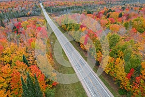 Scenic highway in Michigan upper peninsula surrounded with fall foliage