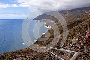 Scenic hiking trail along coastline of Anaga mountain range on Tenerife, Canary Islands, Spain. View on Roque de las Animas crag photo