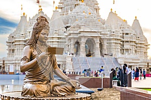 Scenic hindu statue with Akshardham Mahamandir temple in the back at BAPS Swaminarayan Akshardham