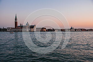 Scenic image of picturesque chanels of Venice siluettes at sunset, Italy