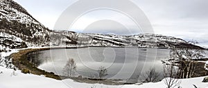 Scenic lake in Norway and snow covered mountains