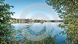 Scenic lake surrounded by lush grassy landscape, Cergy, France photo