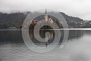 Scenic lakeside landscape featuring a small island in the middle of Lake Bled in Slovenia.