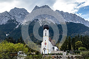 Scenic landscape of Church St Johannes, Wetterstein, Waxenstein and Zugspitze photo