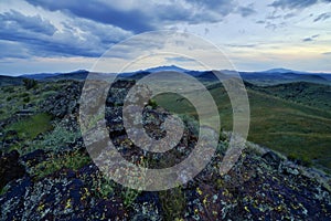 Scenic landscape featuring green hills and a cloudy sky. Colton Crater, Arizona