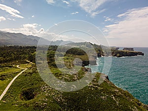 Scenic landscape with green rocky terrain and tranquil sea. Jesters of Arenillas, Spain.