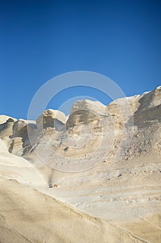 Scenic landscape of a rocky hillside and   a stunning blue ocean in Milos island, Greece