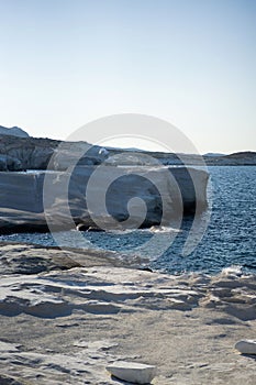 Scenic landscape of a rocky hillside and   a stunning blue ocean in Milos island, Greece