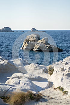 Scenic landscape of a rocky hillside and   a stunning blue ocean in Milos island, Greece