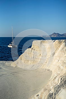 Scenic landscape of a rocky hillside and   a stunning blue ocean in Milos island, Greece