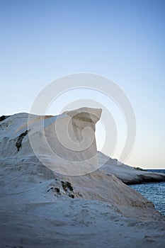 Scenic landscape of a rocky hillside and   a stunning blue ocean in Milos island, Greece