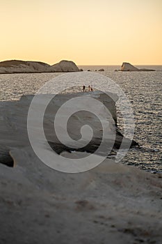 Scenic landscape of a rocky hillside and   a stunning blue ocean in Milos island, Greece