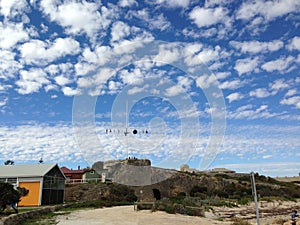 Scenic landscape of small houses on a sunny day with white clouds in the backdrop in  Australia