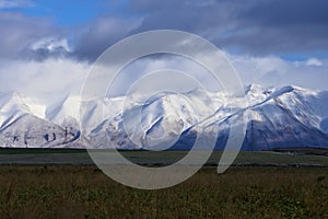 Scenic landscape with snow covered Southern Alps mountain range in the vastness of New Zealand, South Island near Mount Cook