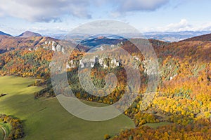 Scenic landscape in Sulov, Slovakia, on beautiful autumn sunrise with colorful leaves on trees in forest and bizarre pointy rocks
