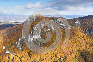 Scenic landscape in Sulov, Slovakia, on beautiful autumn sunrise with colorful leaves on trees in forest and bizarre pointy rocks