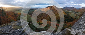 Scenic landscape in Sulov, Slovakia, on beautiful autumn sunrise with colorful leaves on trees in forest and bizarre pointy rocks