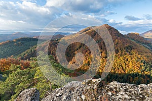 Scenic landscape in Sulov, Slovakia, on beautiful autumn sunrise with colorful leaves on trees in forest and bizarre pointy rocks