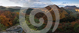 Scenic landscape in Sulov, Slovakia, on beautiful autumn sunrise with colorful leaves on trees in forest and bizarre pointy rocks