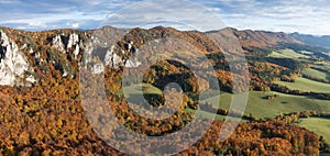 Scenic landscape in Sulov, Slovakia, on beautiful autumn sunrise with colorful leaves on trees in forest and bizarre pointy rocks